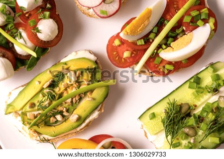 Variety of sandwiches or tapas with bread , cream cheese, vegetable and tasty toppings. Healthy food for lunch or breakfast. Copy space for your text.