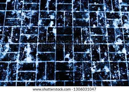 White snow on the black tiles