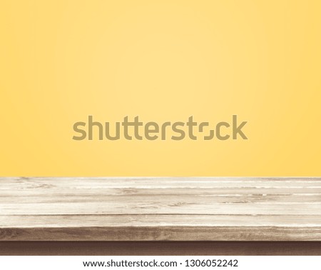 Empty of wood table top on yellow pastel color background.For montage product display or design key visual layout
    
 