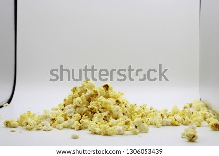 POP CORN BUTTER SALTED CARAMEL FRIED IN OIL for obesity and evening snacking ready to eat popcorn in lightbox shoot against white background