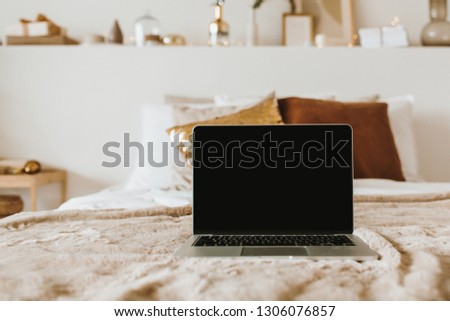Relax, chill with laptop in bed with pillows. Apartment interior design concept. Freelancer, blogger composition. Blank mockup screen hero header for blog, website, social media.