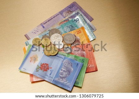 close up of various malaysia rinngit paper currency and coins