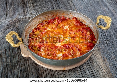 Traditional turkish food menemen made by eggs and tomatoes. Royalty-Free Stock Photo #1306098544
