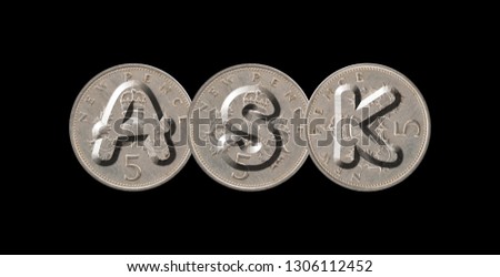 ASK – Coins on black background