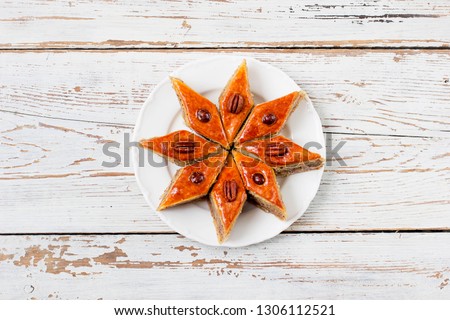 Azerbaijan national pastry pakhlava on white plate on white wooden table ,top view,spring new year celebration Novruz holiday,copy space 