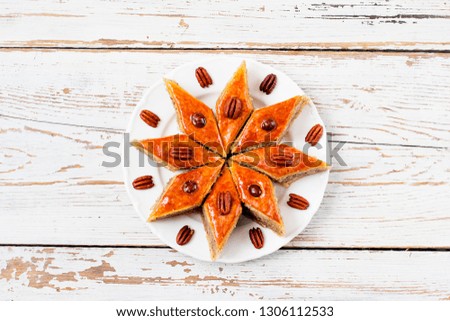 Azerbaijan national pastry pakhlava on white plate on white wooden table ,top view,spring new year celebration Novruz holiday,copy space 