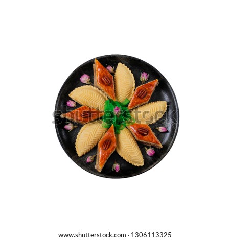 Azerbaijan national pastry pakhlava and shekerbura on tray plate isolated on white,spring new year celebration Novruz holiday,copy space 