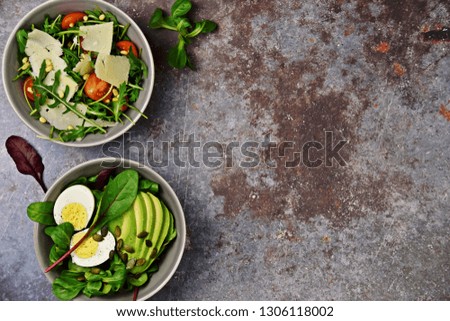 Two fresh salads bowls isolated on dark background. Flat lay salad bowls