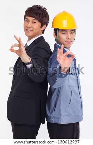Asian business man and engineer show okay signs isolated on white