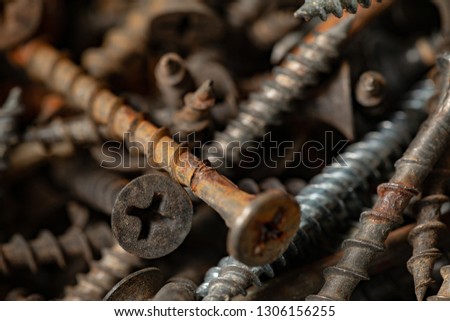 Old rusty screws and nails. Background for construction and industry. Pattern of screws and nails.