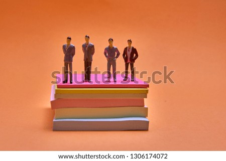 figures of people and stickers on an orange background