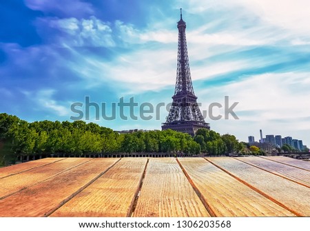Empty surface of a wooden table on a background of eifel tower in Paris, France. Free place.
