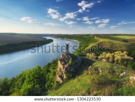 tourist on a cliff above the canyon. man looks at a picturesque canyon