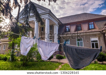 Used women's panties are dried on a rope for linen at the background of the nursing home.