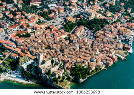 Aerial shot of malcesine from paragliding. Shot includes the entire town and the magnificent castle. Shot includes lake garda