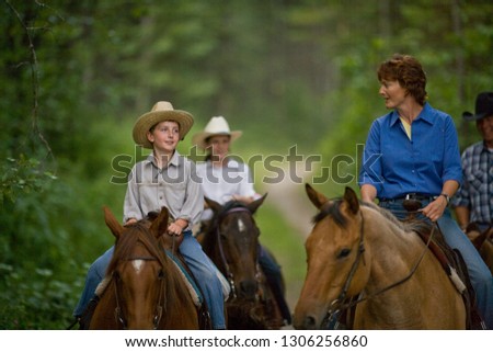 Family on horse trek through forest