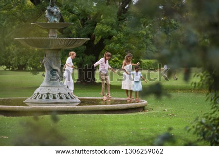Family walking around a fountain
