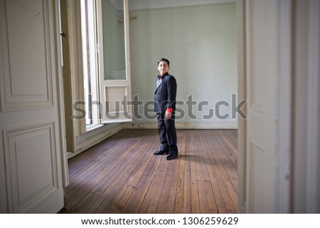 Portrait of a boy standing in a room.