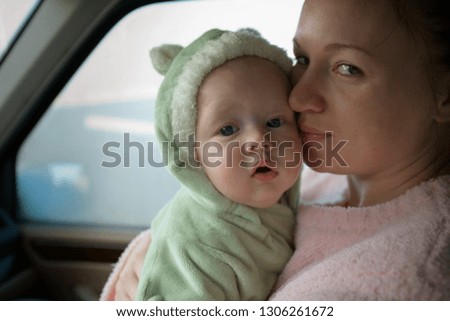 Portrait of a mother holding her young baby