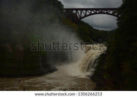 In the Picture, taken in 2018 in Canada, Shows a smaller Waterfall with a huge Railway Bridge in the backround. The Picture Looks breathtaking, due to to the combination of Natur an architekture.