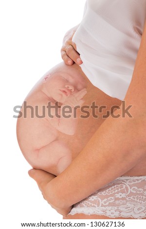 Superimposed newborn baby inside the mother's pregnant belly Royalty-Free Stock Photo #130627136