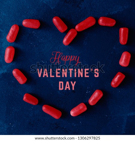 Red candy heart with happy valentines day text for social media graphic.