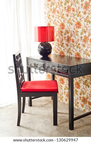Luxury work desk with floral wallpaper next to bright window