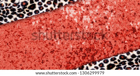 Clashing trendy background with  animal print cloth and metal texture on living coral color fabrick, copy space, text place. Living Coral Color 2019 year concept, sparkling sequined textile