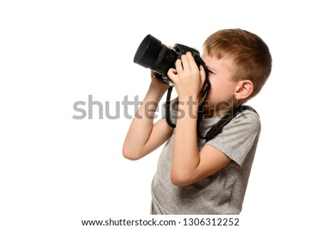Boy takes pictures on the camera. Portrait. Isolate on white background. Side view.