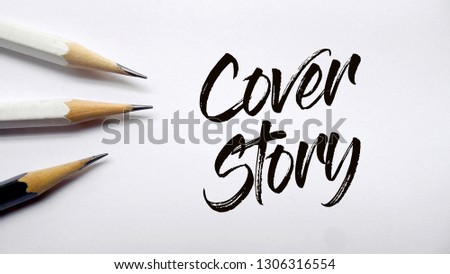 Cover story text memo written on a white background with pencils