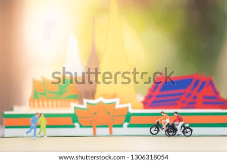 Miniature people : Travelers riding bicycle with copy space using as background traveling or exploring the world, budget travel, health care concepts