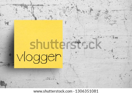 Sticky note on concrete wall, Vlogger