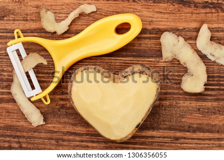 Potato heart over wooden background. Concept - open your feel