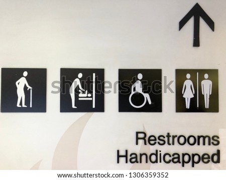 Restroom sign on the wall background. Handicapped toilet sign, Restroom Concept, Toilet icons set. Men and women  signs for restroom.