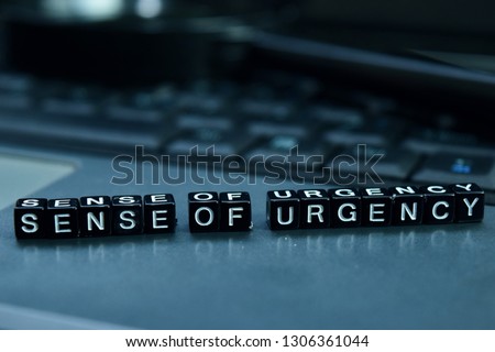 Sense of urgency text wooden blocks in laptop background. Business and technology concept Royalty-Free Stock Photo #1306361044