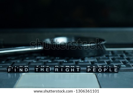 Find the Right People text wooden blocks in laptop background. Business and technology concept