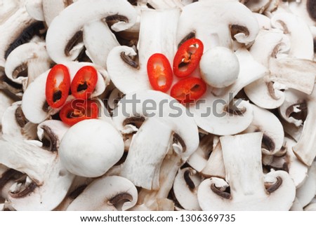 Food background. Sliced champignons with liced chili pepper