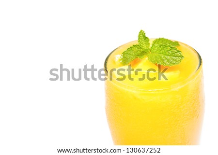 Fresh mango juice in a glass on white background