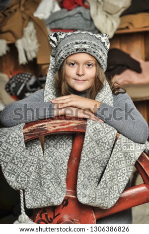 Girl in a gray sweater knitted hat.