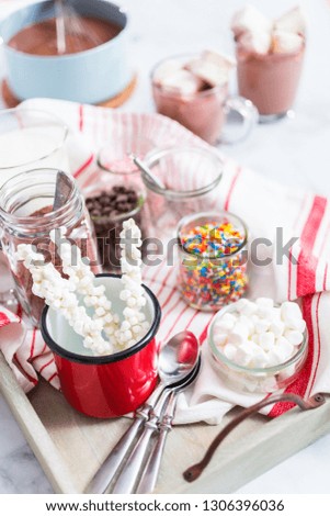 Hot chocolate bar with variety of topping on the tray .