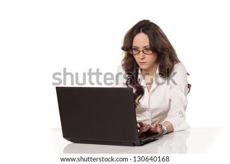 concentrated girl at work on a laptop on white background