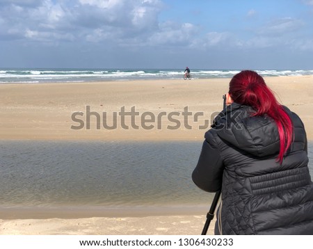 young women is taking a pictures on the sea 