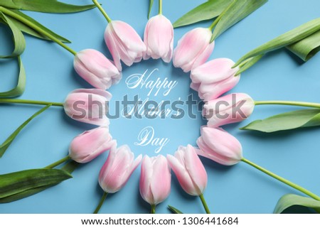 Frame made of beautiful tulips and text Happy Mother's Day on blue background, top view