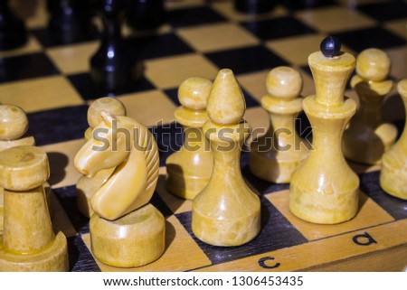 Wooden chess pieces on a wooden board.