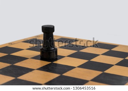 wooden black rook on the chessboard