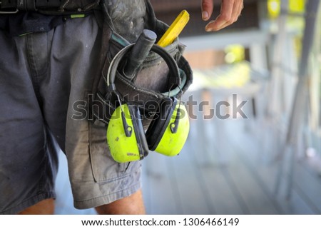 A Carpenter/ tradesman working on a job site with his tools.  Royalty-Free Stock Photo #1306466149