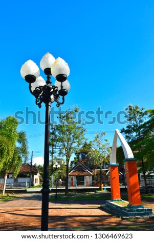lamp post in park with copy space on blue sky