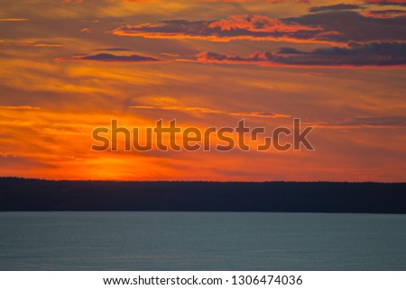 bright orange-red sky at sunset over the river