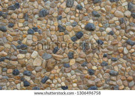 Pebble wall, stones arranged in a natural order, decorated beautifully to be the wall of the house to be as natural as possible.