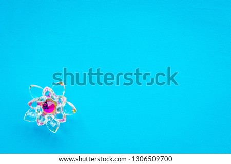 Buddhist symbol. Lotus flower on blue background top view copy space
